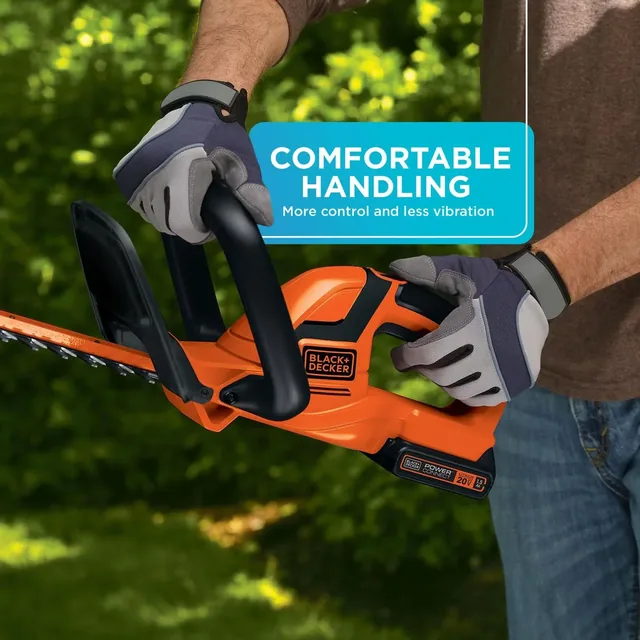 Man trims hedge with the BLACK+DECKER 20V MAX* 22-in. Cordless Hedge Trimmer. Comfortable handling. More control and lesss vibration.