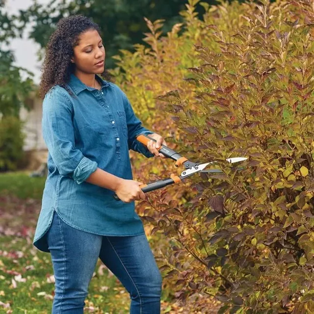 Fiskars PowerGear2 hedge shears used to trim a hedge
