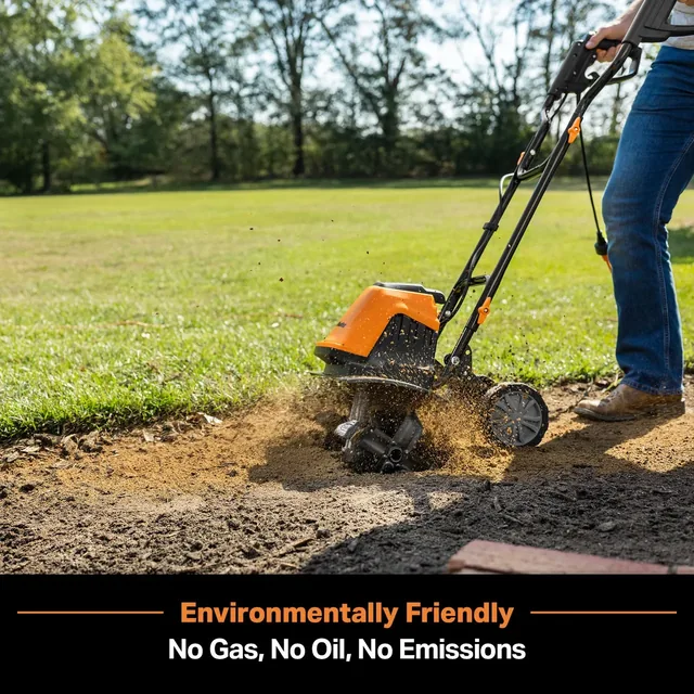 Person using orange electric tiller to aerate soil in lawn with trees in background