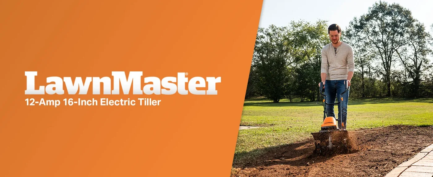 Man operating a LawnMaster 12-Amp 16-Inch Electric Tiller in a garden bed with grass and trees in background.