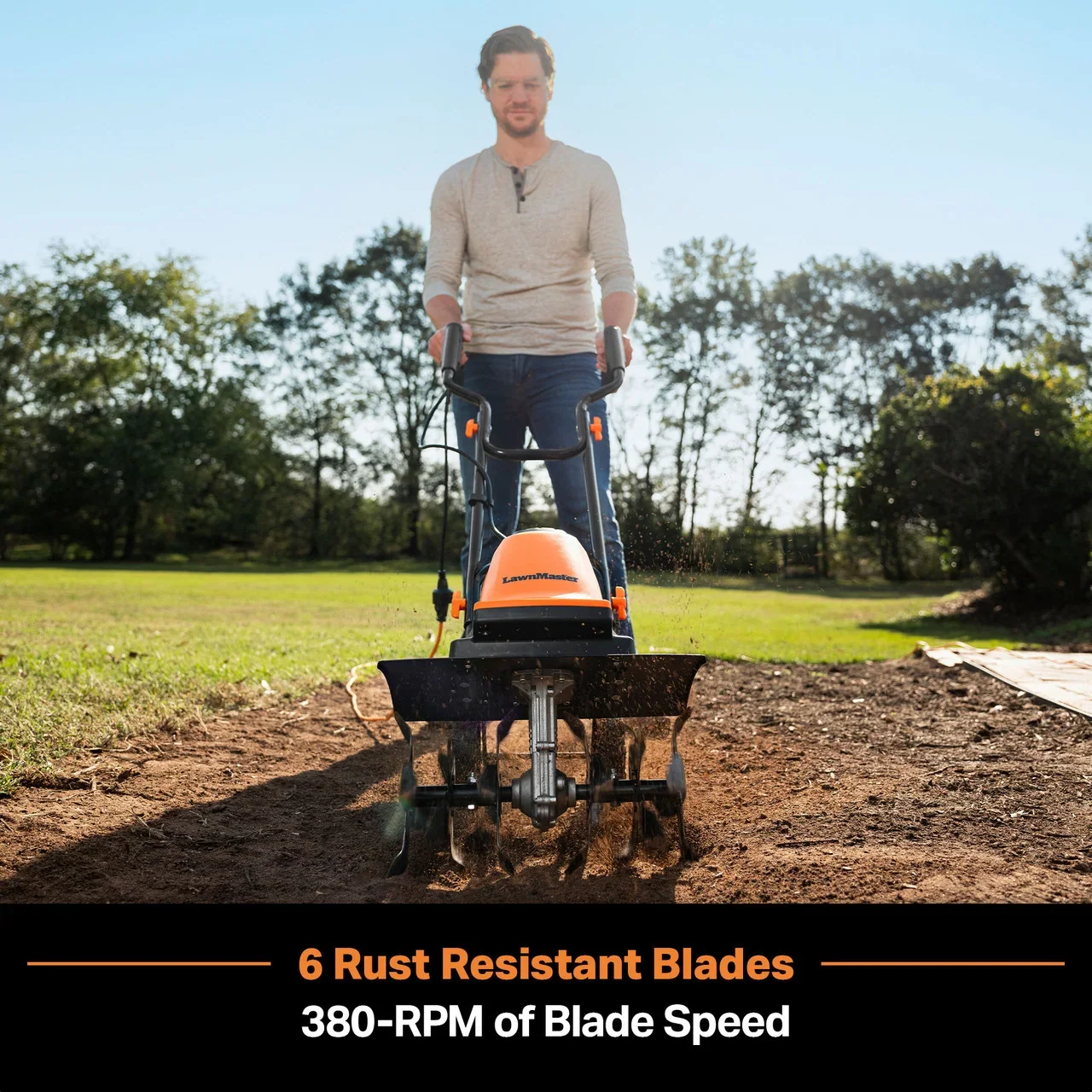 Man operating LawnMaster tiller with 6 rust resistant blades at 380-RPM in garden soil