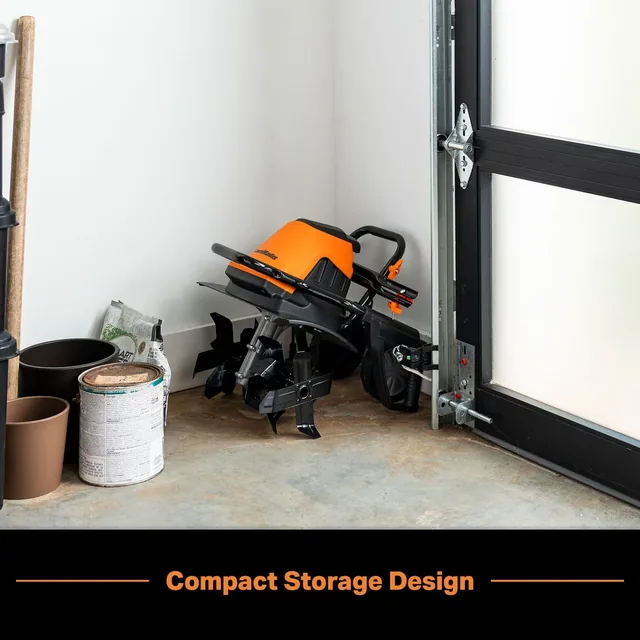 Compact orange and black vacuum stored in garage next to paint cans, demonstrating compact storage design.