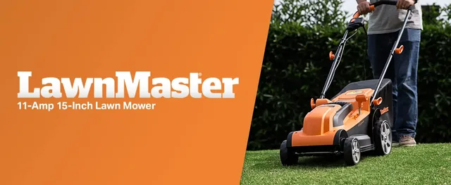 LawnMaster 11-Amp 15-Inch electric lawn mower being used on grass with green hedges in the background