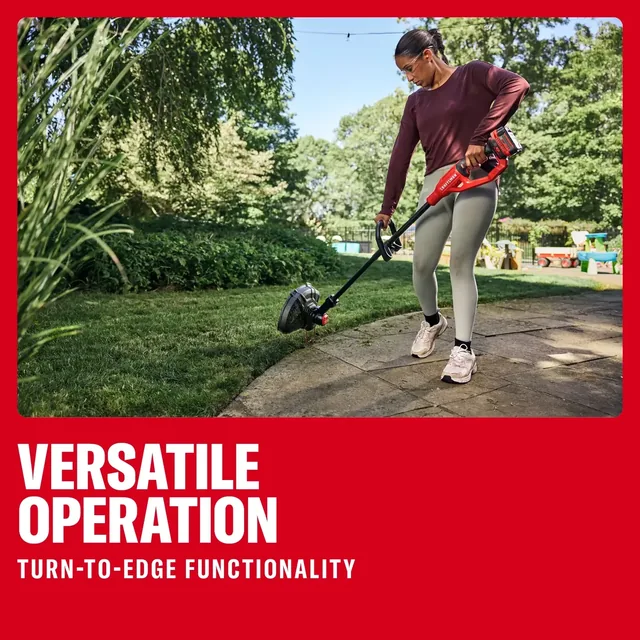 Photo of person using Craftsman cordless string trimmer CMCST901M1 edging lawn next to a stone path outdoors.