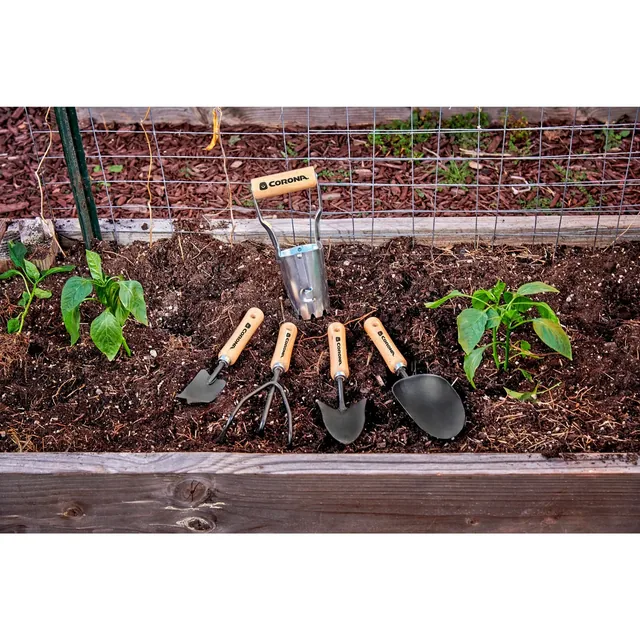 SP10002 short wood-handle tools in a planting bed; the long-handled tool and gloves are separate