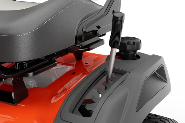 Close-up of a ride-on mower seat and rear wheel, showcasing design details.