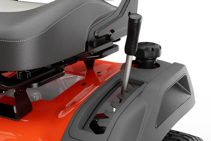 Close-up of a ride-on mower seat and rear wheel, showcasing design details.
